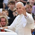 Pope Leo XIV responds to a Cubs fan during a parade in Vatican City