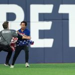 Watch: Fan with American flag runs onto field during World Series game